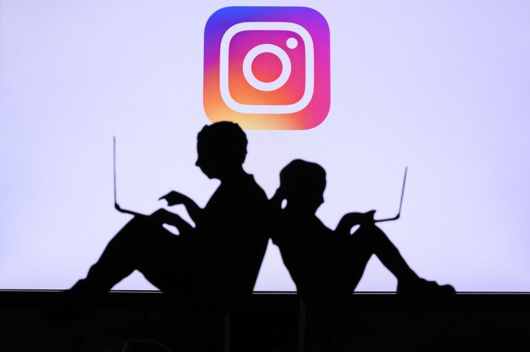 shutterstock_1742511494-1780658743 NEW YORK, USA, 25. MAY 2020: Instagram photo and video-sharing social networking service Children silhouette, sitting together and playing on their laptops. Company logo on screen in background