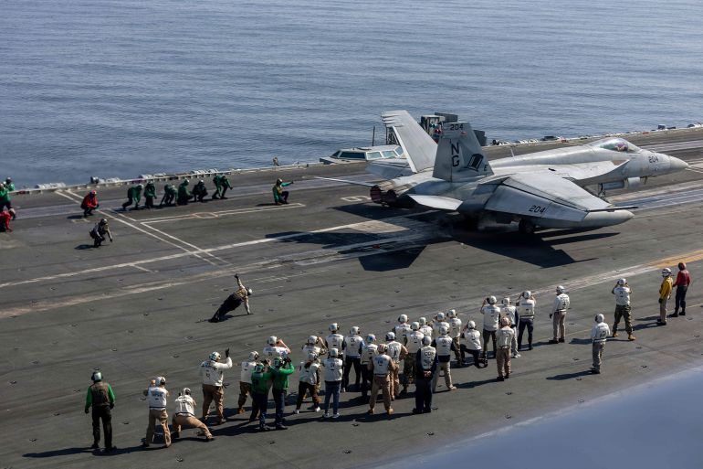 A handout photograph released by the US Navy on February 8, 2026, shows observers including US lead negotiators Steve Witkoff and Jared Kushner, as they watch flight operations on the flight deck of Nimitz-class aircraft carrier USS Abraham Lincoln (CVN 72) in the Arabian Sea, on February 7, 2026. US lead negotiators Steve Witkoff and Jared Kushner visited the USS Abraham Lincoln on February 7, 2026, signalling the persistent threat of US military action against Iran. The US military's Central Command (CENTCOM) said the two top officials visited the nuclear-powered vessel. (Photo by Hannah Tross / US NAVY / AFP) / RESTRICTED TO EDITORIAL USE - MANDATORY CREDIT "AFP PHOTO / US NAVY / MASS COMMUNICATION SPECIALIST SEAMAN HANNAH TROSS" - HANDOUT - NO MARKETING NO ADVERTISING CAMPAIGNS - DISTRIBUTED AS A SERVICE TO CLIENTS / “The erroneous mention[s] appearing in the metadata of this photo by Handout has been modified in AFP systems in the following manner: [Hannah Tross] instead of [Handout]. Please immediately remove the erroneous mention[s] from all your online services and delete it (them) from your servers. If you have been authorized by AFP to distribute it (them) to third parties, please ensure that the same actions are carried out by them. Failure to promptly comply with these instructions will entail liability on your part for any continued or post notification usage. Therefore we thank you very much for all your attention and prompt action. We are sorry for the inconvenience this notification may cause and remain at your disposal for any further information you may require.”