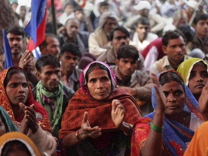 Indian Dalits, member of the outcast community once known as untouchables, applaud a speaker as they participate in a sit in protest on Human Rights Day near the Indian Parliament in New Delhi, India, Tuesday, Dec. 10, 2013. The Dalits were demanding rights to land, livelihood and equal growth opportunities. (AP Photo/Tsering Topgyal)