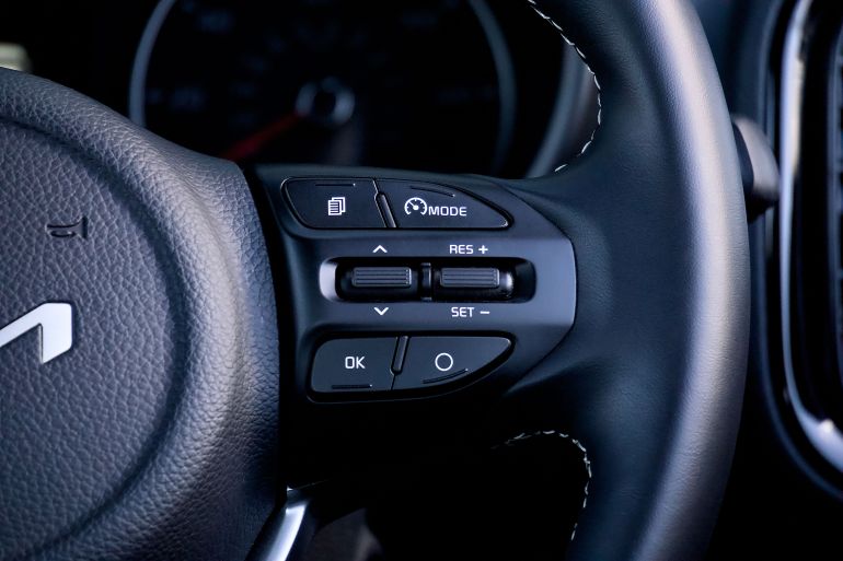 20475101-1790159439 Detailed view of a car steering wheel with control buttons, showcasing modern design and functionality.
