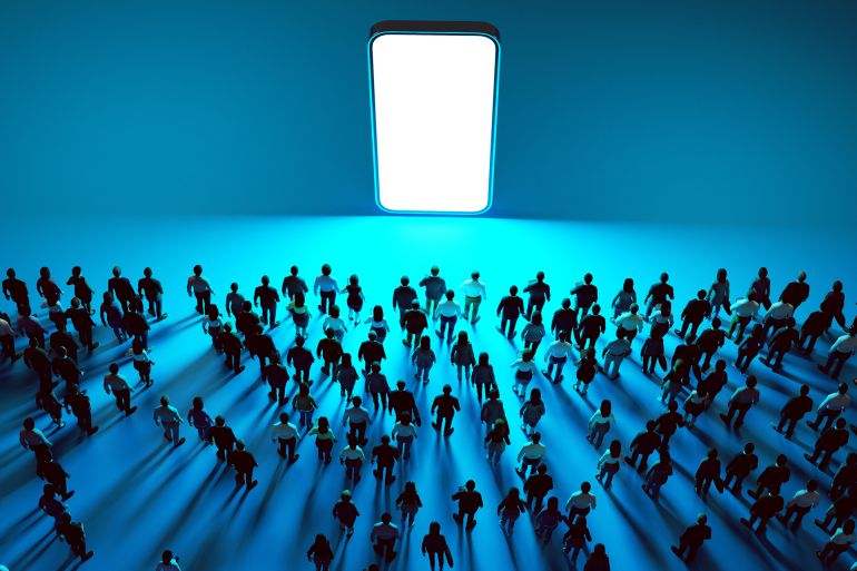 28-1788512887 large crowd of people walking towards a gigantic, vertically positioned smartphone with a glowing white screen, set against a blue background. The people appear to be drawn to the phone as if it is a source of attraction or importance. This visual likely represents the powerful influence and magnetic pull of technology and social media in contemporary society.
