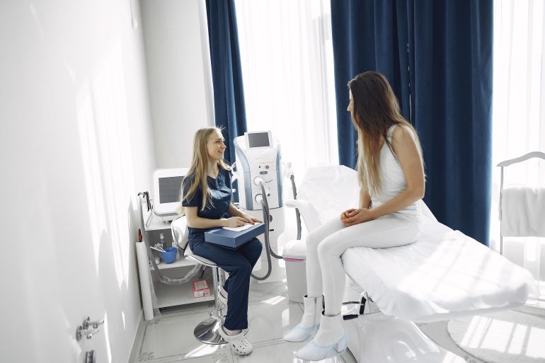 3985301-1788620290 A healthcare professional consulting with a patient in a bright, modern clinic setting.