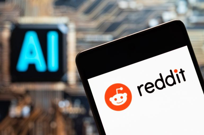 3reddit-1782031839 CHINA - 2023/11/03: In this photo illustration, the American social news aggregation, web content rating and discussion website, Reddit logo seen displayed on a smartphone with an Artificial intelligence (AI) chip and symbol in the background. (Photo Illustration by Budrul Chukrut/SOPA Images/LightRocket via Getty Images)