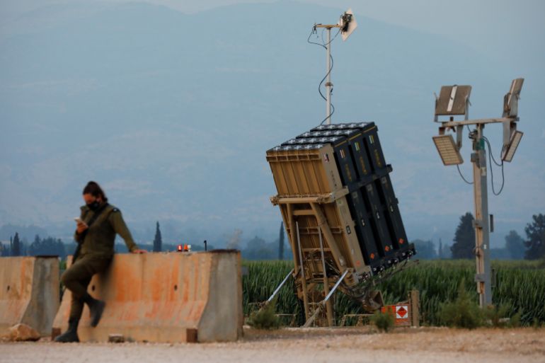 546-1788207629 أنظمة دفاع إسرائيلية An Israeli soldier stands next to an Iron Dome anti-missile system near the Israel's northern border with Lebanon July 27, 2020. REUTERS/Amir Cohen