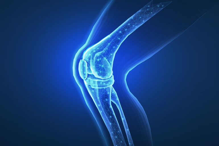6r7yft-1759327127 Knee joint isolated on blue. Bone health, physiotherapy care, joint disorder, glucosamine repair, orthopedic surgery, physical therapy, magnesium supplement, osteoarthritis treatment concept