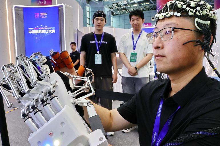 7-1789628355 BEIJING, CHINA - JULY 26: A team member from Yanshan University's Brain-Computer Interface and Intelligent Rehabilitation team demonstrates a brain-controlled wearable robotic hand for active rehabilitation at the 4th China Brain-Computer Interface Contest held at Zhongguancun International Technology Trade Center on July 26, 2026 in Beijing, China. The event showcases advancements in brain-computer interface technology applied to medical rehabilitation. (Photo by Cao Jianxiong/VCG via Getty Images)