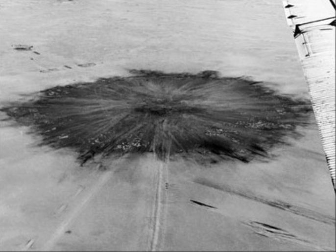 (FILES) This file picture taken 20 February 1960 shows an aerial view of the site of the first French nuclear bomb explosion in the Tanezrouft sahara desert, south-west of Reggane. The head of the Algerian victims of French nuclear tests organisation, Sahara Mohamed Abdelhak Bendjebbar, said 13 February 2007 that his organization will seek compensation through the United Nations' International Court of Justice. Bendjebbar, who did not say when the complaint would be filed, claimed the tests had injured some 30,000 Algerians. Algerian scientists contend that France carried out 17 nuclear tests in the Sahara desert between 1960 and the final withdrawal of French troops from the region in 1967.