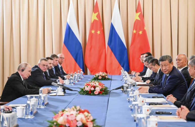 In this pool photograph distributed by the Russian state agency Sputnik, Russia's President Vladimir Putin and China's President Xi Jinping hold a meeting on the sidelines of the Shanghai Cooperation Organisation (SCO) summit in Bishkek on August 31, 2026. (Photo by Kristina Solovyova / POOL / AFP)