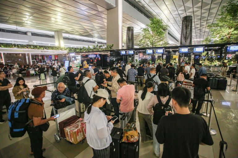 afp_6a9cec019012-1788668929 Stranded passengers wait at a terminal of Soekarno-Hatta Airport in Tangerang on September 6, 2026.