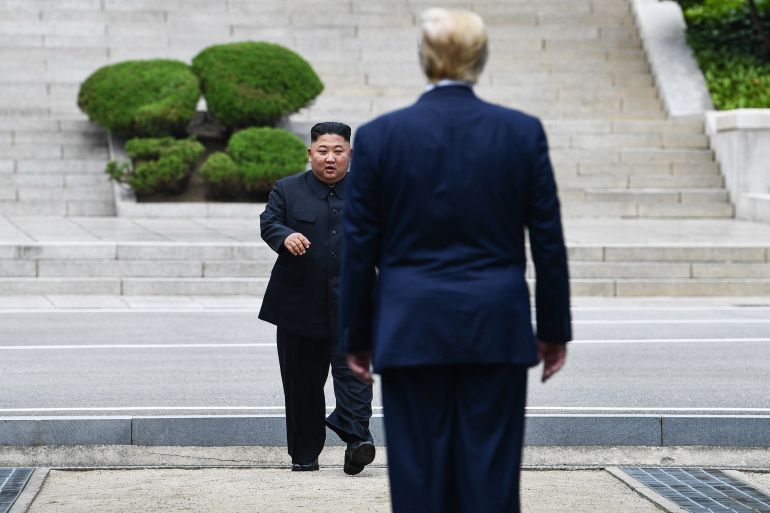 afp_6a9e49631116-1788758371 (FILES) North Korea's leader Kim Jong Un walks to greet US President Donald Trump at the Military Demarcation Line that divides North and South Korea, in the Joint Security Area (JSA) of Panmunjom in the Demilitarized zone (DMZ) on June 30, 2019.