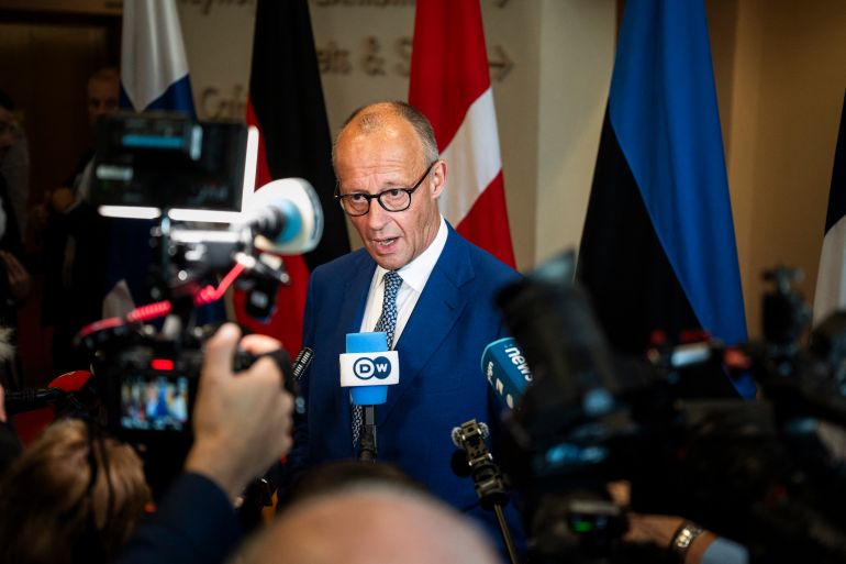 German Chancellor Friedrich Merz speaks with journalists as he arrives at the Arktikum science centre to attend The European Arctic Summit in Rovaniemi, Finland, on September 14, 2026.