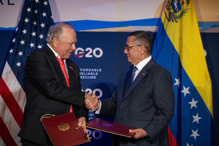 afp_6aab750866db-1789621512 (L/R) Harold Hamm, chairman of Continental Resources, shakes hands with Executive Vice President Jovanny Martinez of the state-owned oil and gas company of Venezuela (PDVSA), after signing an agreement during the third day of the G20 Ministerial Meeting on Energy Abundance in Houston, Texas on September 16, 2026.