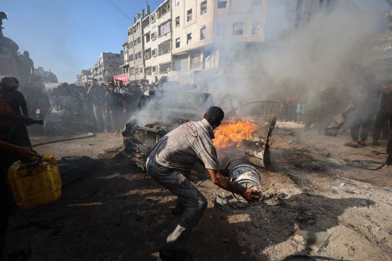 afp_6aaebde5683c-1789836773 Palestinians attempt to extinguish a burning vehicle that was struck by an Israeli airstrike in Gaza City on September 19, 2026.