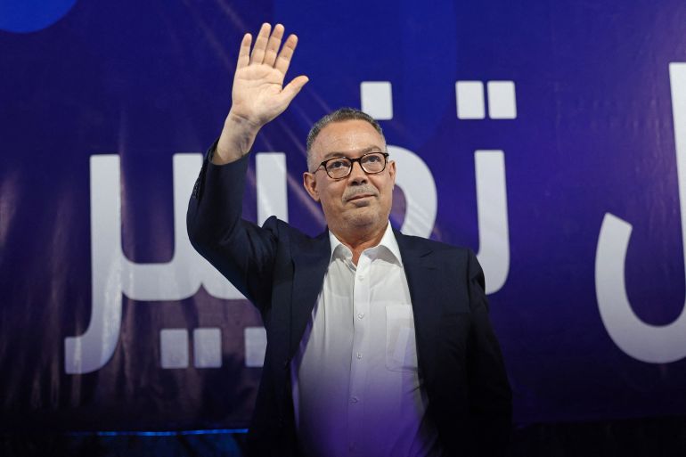 afp_6ab705a91b09-1790379433 Fouzi Lekjaa, president of the Royal Moroccan Football Federation (FRMF), waves during a rally in Benslimane on September 20, 2026, as part of PAM's electoral campaign ahead of Morocco's legislative elections.