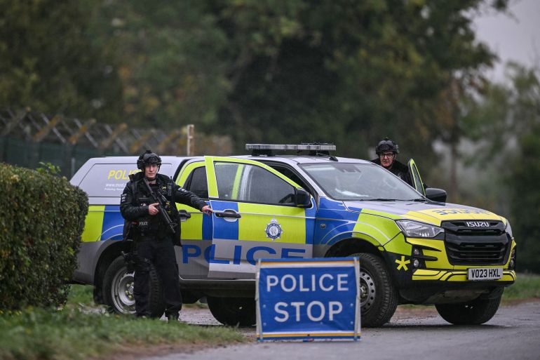 afp_6ab9565d62bf-1790531165 Armed police man a roadblock while posted outside RAF Fairford base in Fairford, south-west England on September 27, 2026, as UK counter-terrorism police investigate an incident near the base in the village of Whelford.
