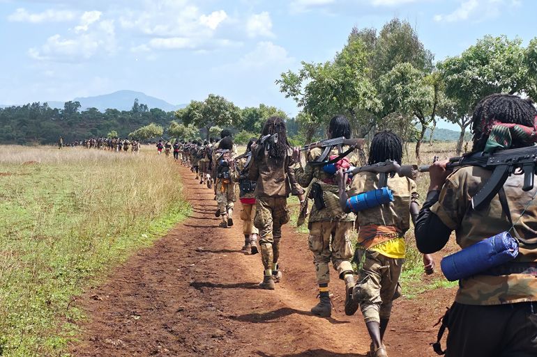 ap25347559148987-1770034564 Oromo Liberation Army (OLA) fighters walk single file carrying rifles in Oromia, Ethiopia, June 2, 2025. (AP Photo)