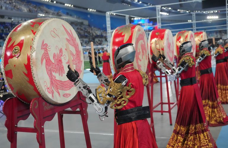 ap_6a9e98080fef5-1788778504 Robots perform during the opening ceremony of the World Humanoid Robot Games in Beijing, Saturday, Aug. 22, 2026. (AP Photo/Achmad Ibrahim)