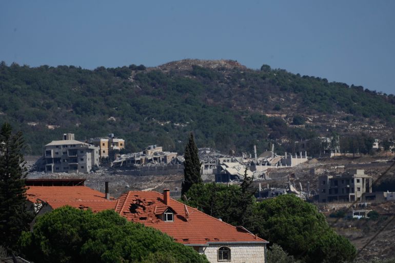 ap_6a9e9de02ace7-1788780000 The Ali Taher Hill is seen in the background overlooking destroyed houses in the southern village of Kfar Rumman, Lebanon, Friday, Sept. 4, 2026. (AP Photo/Mohammed Zaatari)