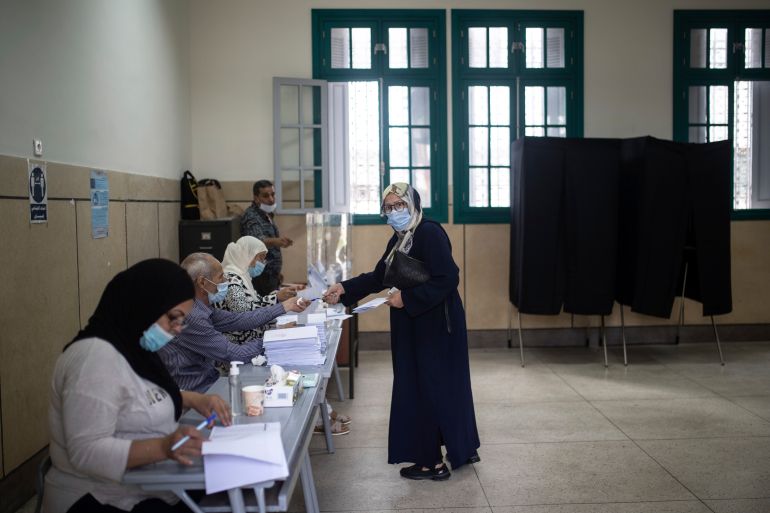 ap_6aa2b69ab8c50-1789048474 A woman prepares to cast her vote inside a polling station in Rabat, Morocco, Wednesday, Sept. 8, 2021. Moroccans are choosing a new parliament and new local leaders in elections reshaped by the pandemic. Candidates are promising to create jobs and boost Morocco’s economy, education and health care. The governing Islamist party is eyeing a third term at the helm of the government if it again wins the most parliament seats. (AP Photo/Mosa'ab Elshamy)