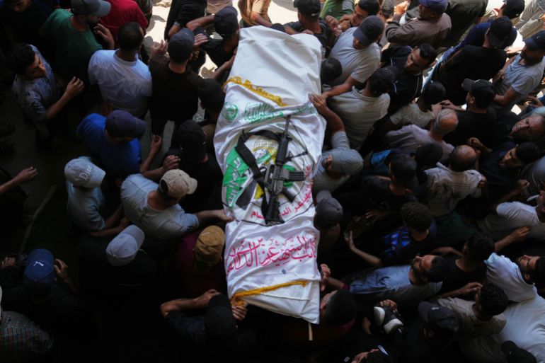 ap_6aa4031758549-1789133591 Palestinian mourners carry the body of Muhammad Yazouri, draped in the flag of the Mujahideen Brigades, a Palestinian militant group, with a rifle laid on top, during his funeral after he was killed in an Israeli airstrike the previous night, in Khan Younis, southern Gaza Strip, Friday, Sept. 11, 2026. (AP Photo/Jehad Alshrafi)