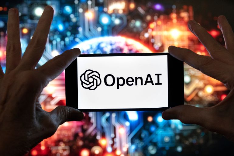 ap_6aae894d979ca-1789823309-1 FILE - The OpenAI logo is displayed on a cell phone in front of an image generated by ChatGPT's Dall-E text-to-image model, Dec. 8, 2023, in Boston. (AP Photo/Michael Dwyer, File)