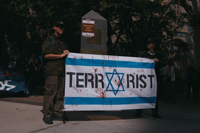 Demonstrators hold a flag near United Nations headquarters during a protest against Israeli Prime Minister Benjamin Netanyahu on Thursday, Sept. 24, 2026, in New York. (AP Photo/Andres Kudacki)