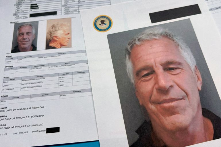 ap_6aba01f039ec9-1790575088 FILE - Documents that were included in the U.S. Department of Justice release of the Jeffrey Epstein files are photographed on Jan. 2, 2026. (AP Photo/Jon Elswick, File)