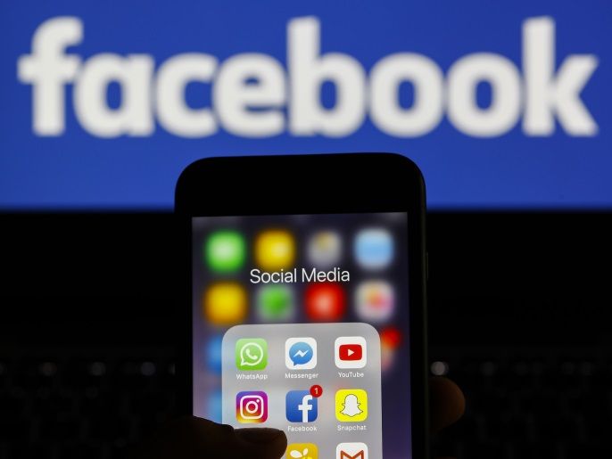 Social Media Applications- - ANKARA, TURKEY - SEPTEMBER 04: Icons of WhatsApp Messenger messaging and Voice over IP service, Instagram social networking service, Social network company Facebook, YouTube video sharing company, Snapchat multimedia messaging app, Twitter news and social networking service, Swarm mobile app, Facebook Messenger messaging platform and Gmail email service applications are seen on a screen of smart phone as the Facebook logo is seen on the back