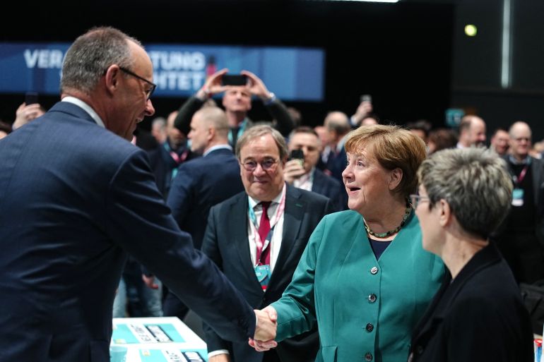 friedrich-merz2-1771656899 German Chancellor and leader of Germany's Christian Democratic Union (CDU) Friedrich Merz (L) greets (R-L) Chair of the Konrad Adenauer Foundation and member of the conservative Christian Democratic Union (CDU) Annegret Kramp-Karrenbauer, former German Chancellor and member of the conservative Christian Democratic Union (CDU) Angela Merkel and CDU politician Armin Laschet at the start of the party congress of Germany's Christian Democratic Union (CDU) in Stuttgart, southern Germany, on February 20, 2026. 20.02.2026, Baden-Württemberg, Stuttgart: Bundeskanzler Friedrich Merz (2.v.l.), CDU-Parteivorsitzender, begrüßt Angela Merkel (2.v.r, CDU), ehemalige Bundeskanzlerin, beim CDU-Bundesparteitag neben Annegret Kramp-Karrenbauer (r, CDU), Leiterin der Konrad-Adenauer-Stiftung und Armin Laschet (3.v.r, CDU), ehemaliger Ministerpräsident von Nordrhein-Westfalen. Die CDU wählt ihre Führungsgremien neu. Für den Vorsitz tritt zum dritten Mal in Folge Kanzler Merz als einziger Kandidat (Photo by Kay Nietfeld / POOL / AFP)