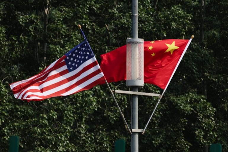 getty_6a043265aa-1778659941 BEIJING, CHINA - MAY 13: The national flags of the United States and China hang on airport highway on May 13, 2026 in Beijing, China. President Donald Trump will arrive in Beijing on May 13th for a two day summit with Chinese President Xi Jinping. It will be the first visit to China by a U.S. President since Trump's last visit in 2017. (Photo by Lintao Zhang/Getty Images)