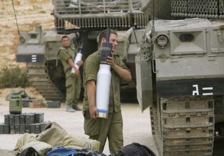 LEBANESE BORDER, ISRAEL - JULY 14: Israeli army tank crew load their Merkeva tanks with armor-piercing ammunition as they prepare for possible action against Hezbollah militants July 14, 2006 on Israel's northern border with Lebanon. Israel has stepped up its action against Hezbollah targets in an effort to drive the Islamic militants from the border and to force the return of two soldiers captured by the group in a cross-border attack two days ago on July 12. (Photo by David Silverman/Getty Images)