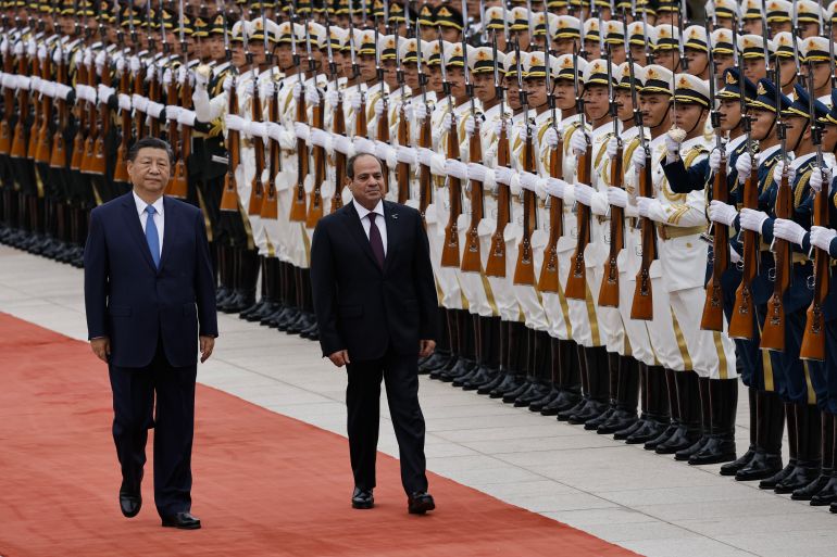 getty_6a96ac1a11-1788259354 BEIJING, CHINA - MAY 29: Chinese President Xi Jinping walks next to Egyptian President Abdel Fattah al-Sisi (C) review the honour guard during a welcome ceremony for Egyptian President Abdel Fattah al-Sisi at the Great Hall of the People on May 29, 2024 in Beijing, China. (Photo by Tingshu Wang-Pool/Getty Images)