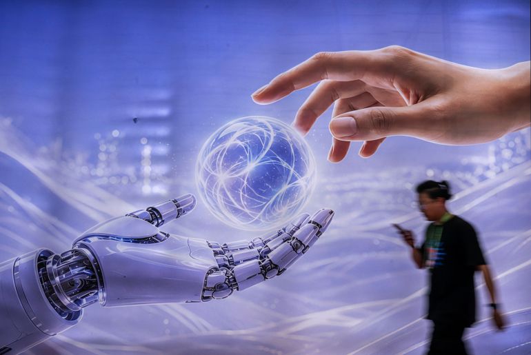 getty_6a9abbd0c7-1788525520 BEIJING, CHINA - JUNE 26: A man walks by a billboard showing a humanoid robot in the AI section at the Chinese International Supply Chain Expo (CISCE) on June 26, 2026 in Beijing, China. China is investing heavily in artificial intelligence and robotics, pouring billions of dollars into what the government sees as the country’s next economic engine. There are thousands of Chinese companies across a sprawling sector that includes humanoid robot and embodied intelligence, AI models, factory automation, and AI for autonomous systems. China remains in a race with the United States for dominance in AI technologies with products that are cheaper to manufacture and have commercial appeal. (Photo by Kevin Frayer/Getty Images)