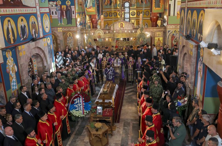 getty_6a9f09cd1a-1788807629 BELGRADE, SERBIA - SEPTEMBER 7: An orthodox priest blesses the coffin of late Bosnian Serb military leader Ratko Mladic on the day of the funeral for Ratko Mladic at St. Luka Church on September 7, 2026 in Belgrade, Serbia. On August 27th, Serbian state media announced that the Bosnian Serb general Ratko Mladic, who was serving a life sentence in The Hague prison for war crimes during the 1992-95 war in Bosnia, died while in a prison hospital. (Photo by Srdjan Stevanovic/Getty Images)