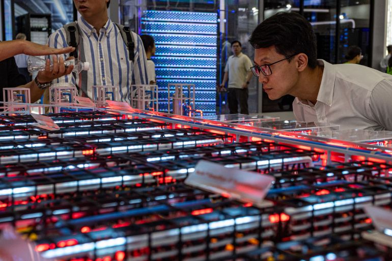 getty_6aaa7d1976-1789558041 TAIPEI, TAIWAN - JUNE 03: An attendee leans in to carefully examine the modular grid layout and server configurations of a large data center hardware model on June 03, 2026 in Taipei, Taiwan. Running June 2–5 across four venues in Taipei's Nangang and Xinyi districts under the theme "AI Together," the annual trade show has drawn more than 1,500 exhibitors and industry heavyweights including NVIDIA CEO Jensen Huang to showcase next-generation AI chips, robotics, and computing infrastructure, cementing Taiwan's role as the world's pre-eminent hub for semiconductor and AI supply chain innovation. (Photo by Cheng Chia Huang/Getty Images)