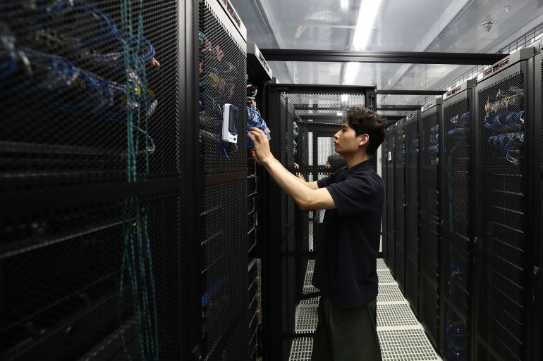 getty_6aafba7977-1789901433 SUWON, SOUTH KOREA - JUNE 13: (EDITORIAL USE ONLY) An employee checks a server room in the Samsung Networks' Telco Data Center at the Samsung Electronics HQ, Samsung Digital City, on June 13, 2023 in Suwon, South Korea. Established in 1969, Samsung Digital City is the birthplace of Samsung Electronics. It previously housed manufacturing lines for many Samsung products before becoming an R&D center in the early 2000s. The Samsung Digital City is a major office park it serves as the IT and electronics hub for the multinational corporation Samsung. Within 390 acres of office space, there are almost 37,000 Samsung employees, 4 landmark office towers, up to 37 floors high, 131 buildings with more labs, offices, recreational facilities, and a guesthouse for visiting researchers. (Photo by Chung Sung-Jun/Getty Images)