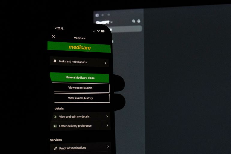 MELBOURNE, AUSTRALIA - SEPTEMBER 24: In this photo illustration, the Medicare application is open on a phone held in front of a computer screen with ChatGpt open in the background on September 24, 2026 in Melbourne, Australia. The AI agent "hacked a statistics portal containing private data from Australia's universal healthcare scheme, Medicare," local media reports said, which experts believe is "the world's first known AI breach of a government system." (Photo by Asanka Ratnayake/Getty Images)