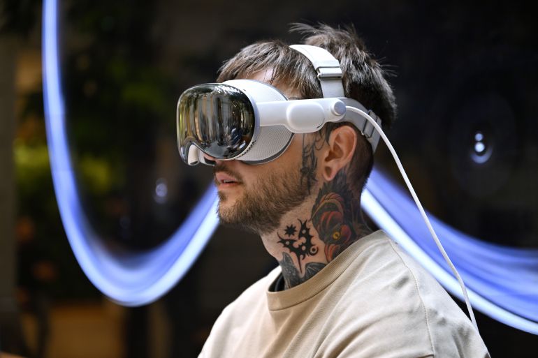 getty_6abafcde14-1790639326 PARIS, FRANCE - JULY 12: A customer tries the device for the first time at the Apple Champs-Élysées store during the launch of the Apple Vision Pro on July 12, 2024 in Paris, France. The Vision Pro will also be available in store and online in Australia, Canada, Germany and the United Kingdom. (Photo by Kristy Sparow/Getty Images for Apple)