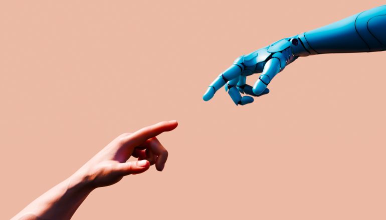 gettyimages-2264634321-1788361187 Description: Conceptual image featuring a human hand and a blue robotic limb reaching toward each other with index fingers extended against a peach background. This horizontal composition is a modern take on classical art, representing the synergy and connection between human representation and artificial intelligence. The image serves as a powerful metaphor for the digital transformation of society and the growing partnership - teamwork between biology and technology. It highlights concepts of innovation, discovery, and the next step in global business evolution through robotic process automation. This digitally generated image explores the potential for a helping hand and cooperation in a futuristic smart city environment. By showcasing the proximity of the organic human limb and the mechanical machinery, the visual narrative emphasizes the integration of machine learning and engineering. It represents the way forward for communication, growth, and the shared future of humanity and robotics.