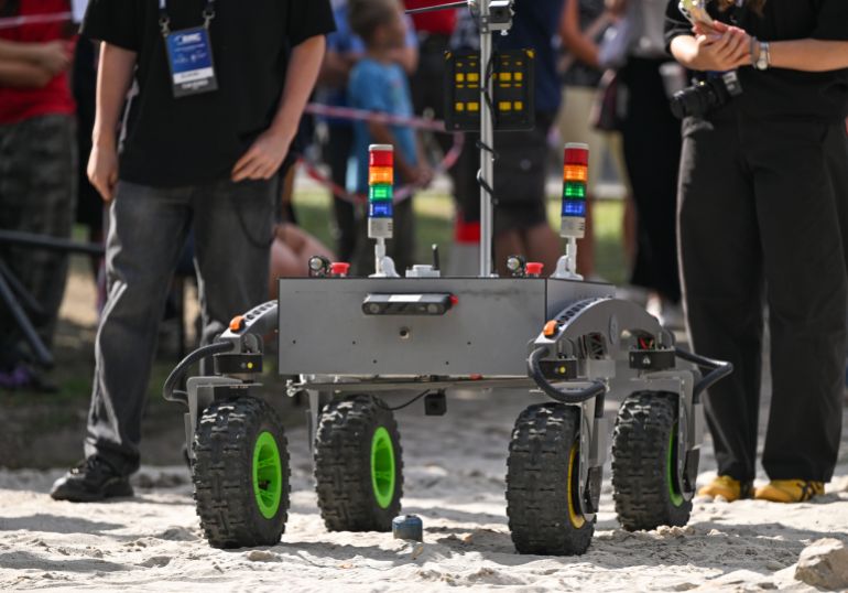 gettyimages-2293258370-1789924374 KRAKOW, POLAND - SEPTEMBER 5: The four-wheeled planetary rover Indomitus, engineered by the student team from Ukrainian Catholic University (UCU Space Robotics), stands on the sand track with its status indicator lights illuminated during the 12th European Rover Challenge at AGH University of Krakow on September 5, 2026, in Krakow, Poland. (Photo by Artur Widak/NurPhoto via Getty Images)