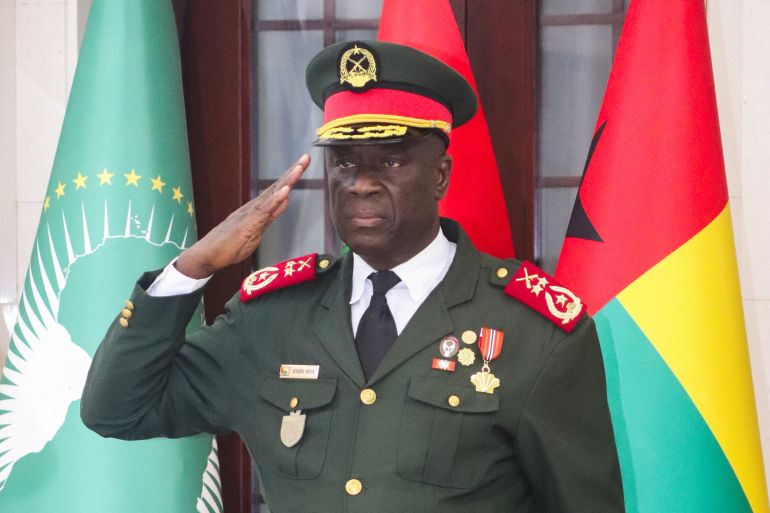 reuters_693a92c0-1765446336 Major-General Horta Inta-a, the new transitional president, salutes during the swearing-in ceremony of Major-General Tomas Djassi as the new chief of staff of the Armed Forces in Bissau, Guinea-Bissau November 27, 2025. REUTERS/Delcyo Sanca