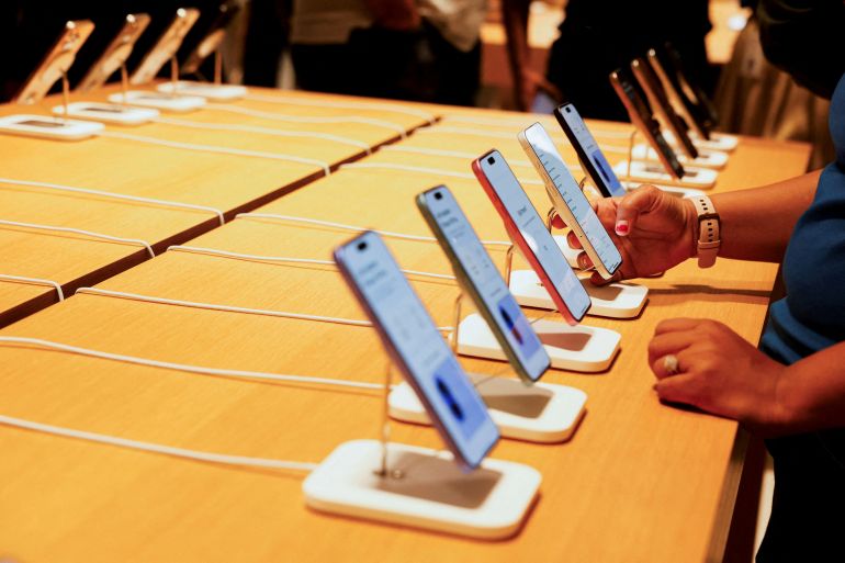 FILE PHOTO: A person holds an Apple iPhone at the company's first retail store in Bengaluru, India, September 2, 2025. REUTERS/Priyanshu Singh REFILE - QUALITY REPEAT/File Photo