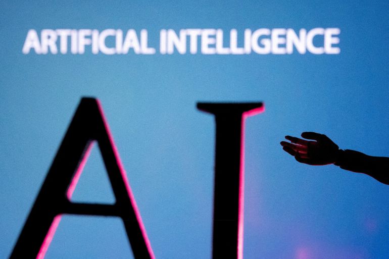 FILE PHOTO: AI (Artificial Intelligence) letters and robot hand miniature in this illustration taken, June 23, 2023. REUTERS/Dado Ruvic/Illustration/File Photo