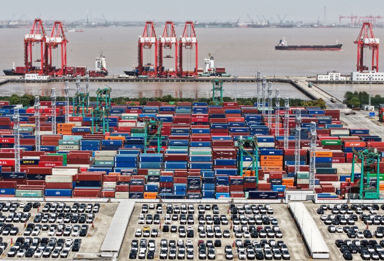 reuters_6a785839-1786271801 FILE PHOTO: A drone view shows electric vehicles (EV) for export and containers sitting at a port in Shanghai, China April 13, 2025. China Daily via REUTERS ATTENTION EDITORS - THIS PICTURE WAS PROVIDED BY A THIRD PARTY. CHINA OUT. NO COMMERCIAL OR EDITORIAL SALES IN CHINA./File Photo