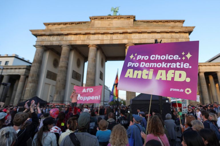 reuters_6a9f4f64-1788825444 Demonstrators hold banners during a protest the day after the victory of the far-right Alternative for Germany (AfD) party in state elections in Saxony-Anhalt at the Brandenburg Gate in Berlin, Germany, September 7, 2026. REUTERS/Maryam Majd