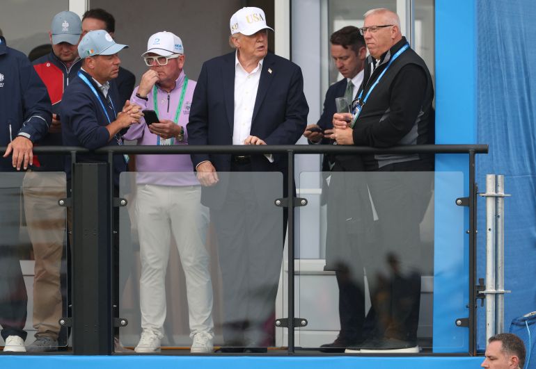 reuters_6aa5cb4b-1789250379 U.S. President Donald Trump speaks with a man as he watches golf at Trump International Golf Links in Doonbeg, County Clare, Ireland, September 12, 2026. REUTERS/Cathal McNaughton