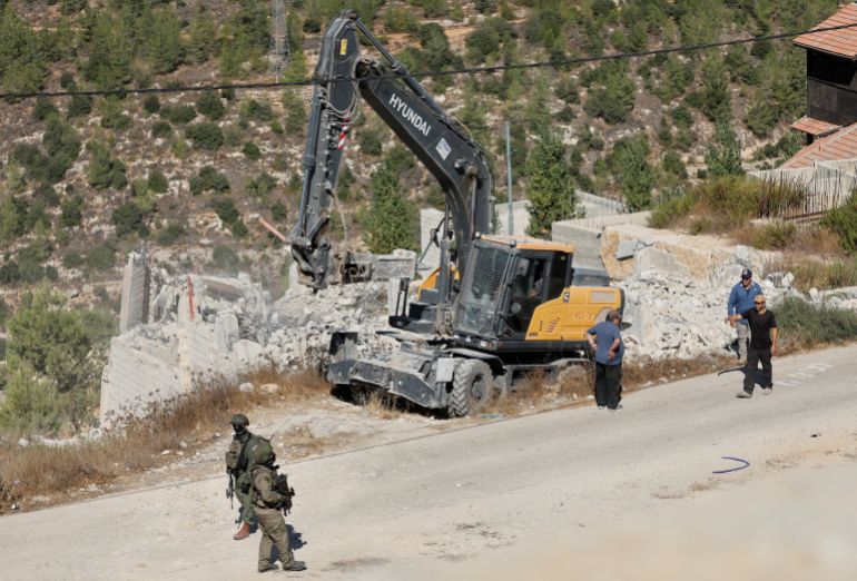 reuters_6aa7b795-1789376405-1 Israeli forces stand guard near heavy machinery during the demolition of a Palestinian building in Battir near Bethlehem in the Israeli-occupied West Bank, September 10, 2026. REUTERS/Mussa Qawasma REFILE - CORRRECTING LOCATION FROM "NEAR HEBRON" TO "IN BATTIR NEAR BETHLEHEM".