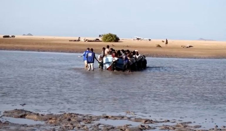 Staff walk towards a boat carrying refugees from Yemen, fleeing clashes between Houthi fighters and Saudi-backed Yemeni government forces, after arriving in Djibouti, September 12, 2026, in this screen grab taken from a video. International Organization for Migration/Handout via REUTERS ATTENTION EDITORS - THIS IMAGE HAS BEEN SUPPLIED BY A THIRD PARTY. NO RESALES. NO ARCHIVES