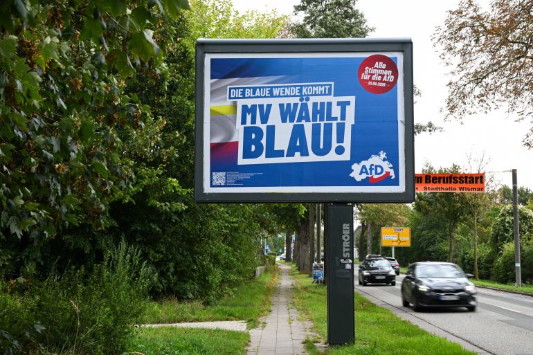 reuters_6aaf7ff2-1789886450 Cars drive past a campaign poster of the far-right party Alternative for Germany (AfD) ahead of the Mecklenburg-Western Pomerania state elections in Wismar, Germany, September 19, 2026. REUTERS/Annegret Hilse