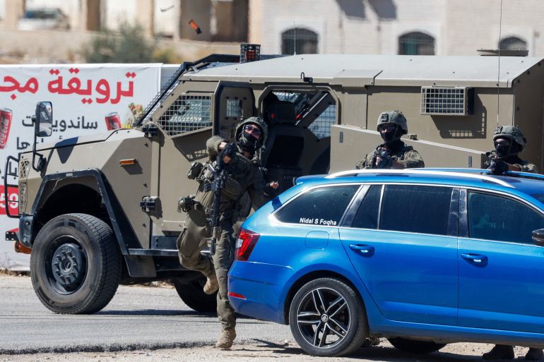 reuters_6ab02672-1789929074 An Israeli soldier hurls a sound grenade during a raid outside H-Clinic Specialized Hospital in the Palestinian city of Ramallah in the Israeli-occupied West Bank, September 20, 2026. REUTERS/Mohammed Torokman